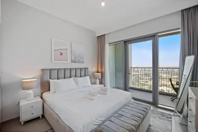 a bedroom with a large bed and a large window at Experience the Downtown Views Perfect 2BR wt Balco in Dubai