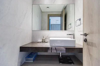 a bathroom with a sink and a mirror at Oxford Boulevard - 1 BR Apartment - Allsopp & Allsopp in Dubai