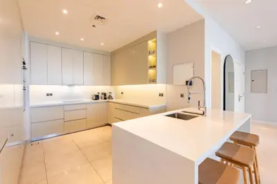 a kitchen with white cabinets and a white counter top at Stunning Sea View 3BR with Private Beach in Dubai