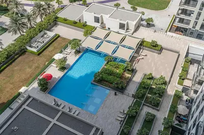 an overhead view of a house with a swimming pool at Bright 1BR APT in Dubai Hills Near Burj Khalifa in Dubai
