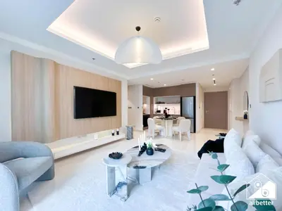 a living room with a couch and a tv at Elegant 1B by the Beach & iconic Views in Dubai