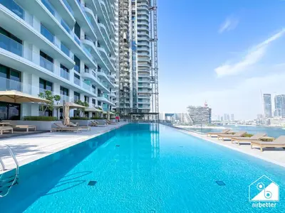 a swimming pool in the middle of a building at Elegant 1B by the Beach & iconic Views in Dubai