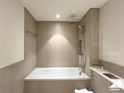 a bathroom with a bath tub and a shower at Elegant 1B by the Beach & iconic Views in Dubai