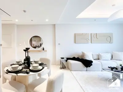 a white living room with a white couch and a table at Elegant 1B by the Beach & iconic Views in Dubai