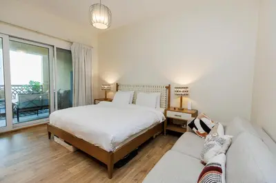 a bedroom with a large bed and a couch at Panoramic Palm Jumeirah view 1 BedRoom Apartment- Holistay Luxury Collection in Dubai