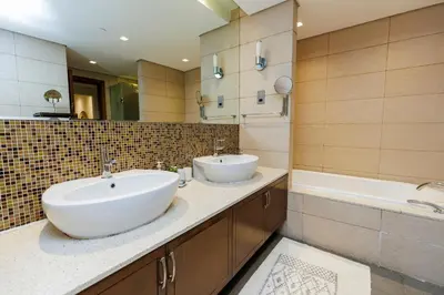a bathroom with two sinks and a large mirror at Panoramic Palm Jumeirah view 1 BedRoom Apartment- Holistay Luxury Collection in Dubai