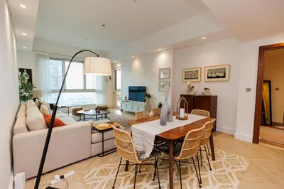 a living room with a table and a couch at Panoramic Palm Jumeirah view 1 BedRoom Apartment- Holistay Luxury Collection in Dubai