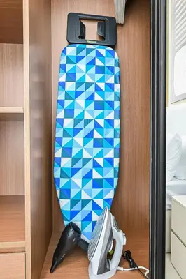 a blue and white surfboard in a closet at Golden Stays - Binghatti Tulip I Chic 1BR Apartment I Balcony Views I JVC Dubai in Dubai