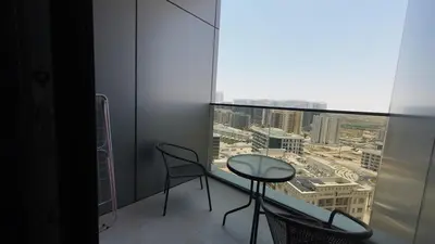 a room with a table and chairs and a large window at High Floor 2 Bedroom in V Tower in Dubai
