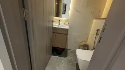 a bathroom with a toilet and a sink at High Floor 2 Bedroom in V Tower in Dubai