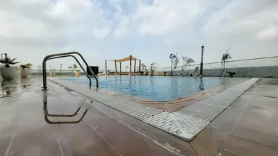 a swimming pool with a slide in the middle of a building at Cozy Studio Themed Designed In JVT in Dubai