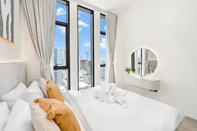 a bedroom with a large white bed with a large window at Golden Stays - Private Pool in Binghatti Tulip I Prime JVC 2BR I Balcony Access in Dubai