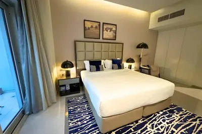 a bedroom with a large white bed and a window at Stunning Burj Views Studio Mins to Dubai Mall 603 in Dubai