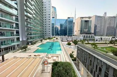 a view of a pool in a city with buildings at Stunning Burj Views Studio Mins to Dubai Mall 603 in Dubai