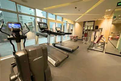 a gym with treadmills and ellipticals in a building at Stunning Burj Views Studio Mins to Dubai Mall 603 in Dubai