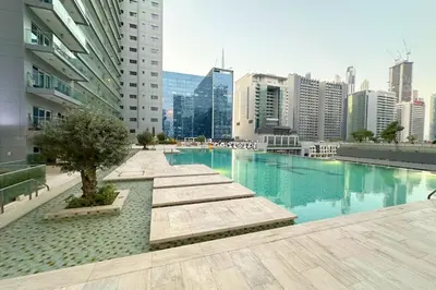 a swimming pool in the middle of a city with buildings at Stunning Burj Views Studio Mins to Dubai Mall 603 in Dubai