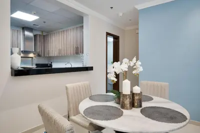 a dining room with a table and chairs at Elegant 1BR near from Dubai Mall & Burj Khalifa in Dubai