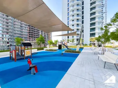 a playground with a slide and a child on a skateboard at Seaside 1BR Retreat , Beach & Atlantis Views in Dubai