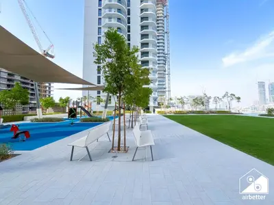 a park with benches and trees in a building at Seaside 1BR Retreat , Beach & Atlantis Views in Dubai