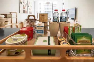 a wooden tray with food and drinks on a table at District One Dubai Lagoon View Near Downtown in Dubai
