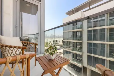 a balcony with a wooden bench and a table at District One Dubai Lagoon View Near Downtown in Dubai