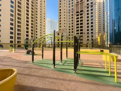 a playground with a yellow slide in a city at Modern 1BR in JBR, Walk to Beach & Marina in Dubai