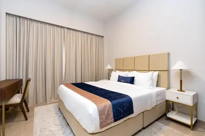 a hotel room with a large bed and a desk at CitiHome Elegant Finishing Prime Location in Dubai