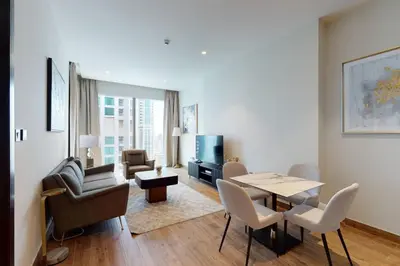 a living room with a couch and a table at Citihome - Luxury 1BR Dubai Marina in Dubai
