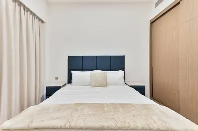 a bedroom with a large bed with a black headboard at Citihome Luxury Finishing 1BR City View in Dubai