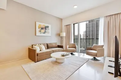 a living room with a couch and a tv at Citihome Luxury Finishing 1BR City View in Dubai