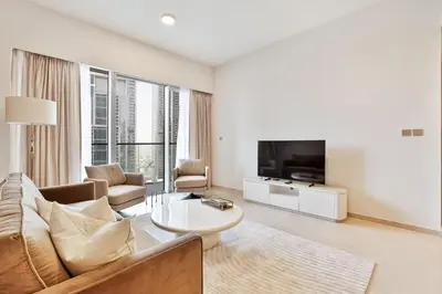 a living room with a couch and a tv at Citihome Luxury Finishing 1BR City View in Dubai