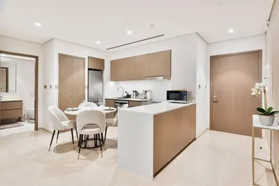 a kitchen and dining room with a table and chairs at Citihome Luxury Finishing 1BR City View in Dubai