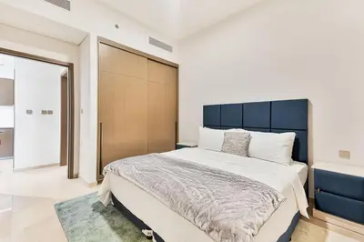 a bedroom with a large bed with a blue headboard at CitiHome Prime Location High End Living in Dubai