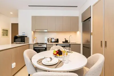 a kitchen with a table with a bowl of fruit on it at CitiHome Modern and Cozy Prime Location in Dubai