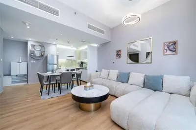 a living room with a couch and a table at Upgraded Bay Central 1 Bed - Marina and Pool View in Dubai