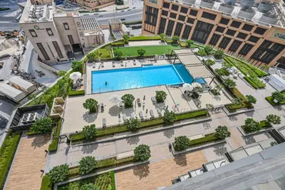 an overhead view of a building with a swimming pool at 1BR Stay in Burj Crown, Dubai in Dubai