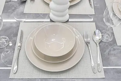 a table with plates and silverware on a table at 1BR Stay in Burj Crown, Dubai in Dubai