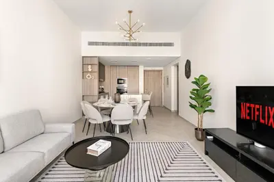 a living room with a couch and a table at VayK - Stylish 2BR with Premium Amenities in JVC in Dubai