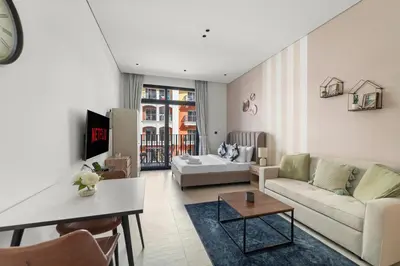 a living room with a couch and a table at VayK - Contemporary and Cozy Studio in JVC in Dubai