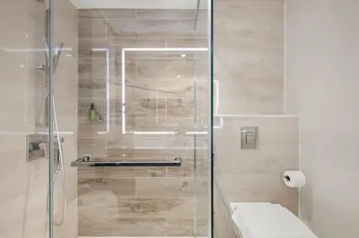 a bathroom with a glass shower with a toilet at VayK - Luxurious 1BR in JLT with Premium Amenities in Dubai