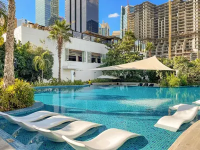 a swimming pool with lounge chairs and buildings at VayK - Luxurious 1BR in JLT with Premium Amenities in Dubai