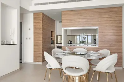 a dining room with a table and white chairs at VayK - Luxurious 1BR in JLT with Premium Amenities in Dubai