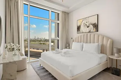 a bedroom with a large white bed and a large window at VayK - Luxurious 1BR in JLT with Premium Amenities in Dubai