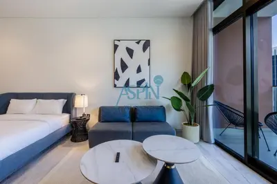 a living room with a couch and a table at Iconic Burj Khalifa View- Aspin Studio in Dubai