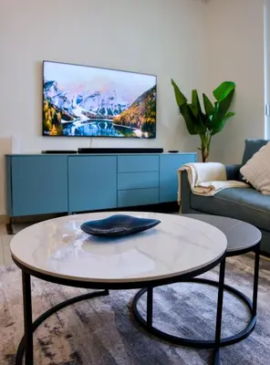 a living room with a tv and a coffee table at Sobha Hartland Greens 2BR near Dubai Mall in Dubai