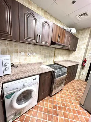 a kitchen with a washer and dryer in it at Comfort Corner In Al Barsha 1 near Mall of Emirates in Dubai