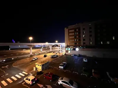 a parking lot at night with cars parked in it at Cozy Barsha Spot In Barsha 1 in Dubai