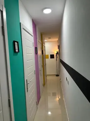 a hallway with different colored doors in a hallway at Solo Comfort Corner In Barsha 1 in Dubai