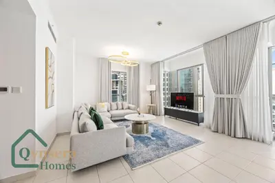 a living room with a couch and a table at Iconic Burj & Fountain View Retreat! in Dubai