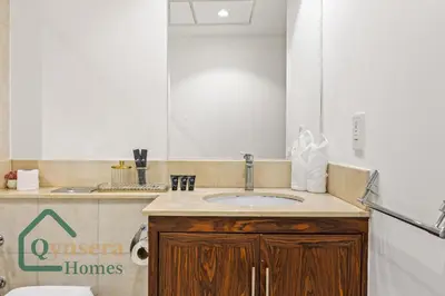 a bathroom with a sink and a toilet at Iconic Burj & Fountain View Retreat! in Dubai